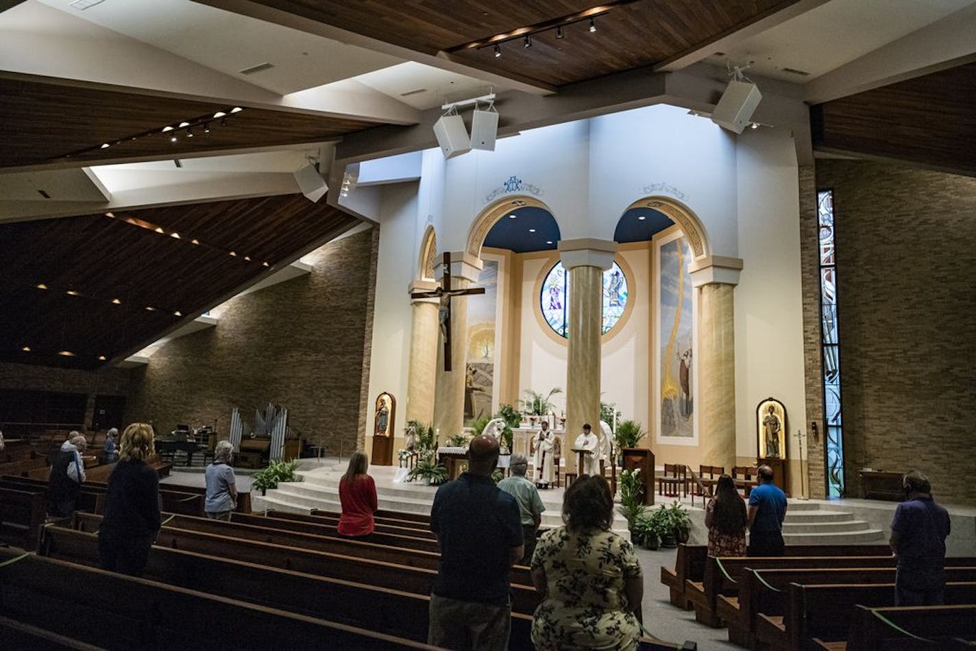 At Transfiguration Catholic Church in Oakdale, parishioners were able to attend a service by Father John Paul Erickson on Wednesday as pews were closed off to allow social distancing and a maximum capacity of 250 or less than 25%.