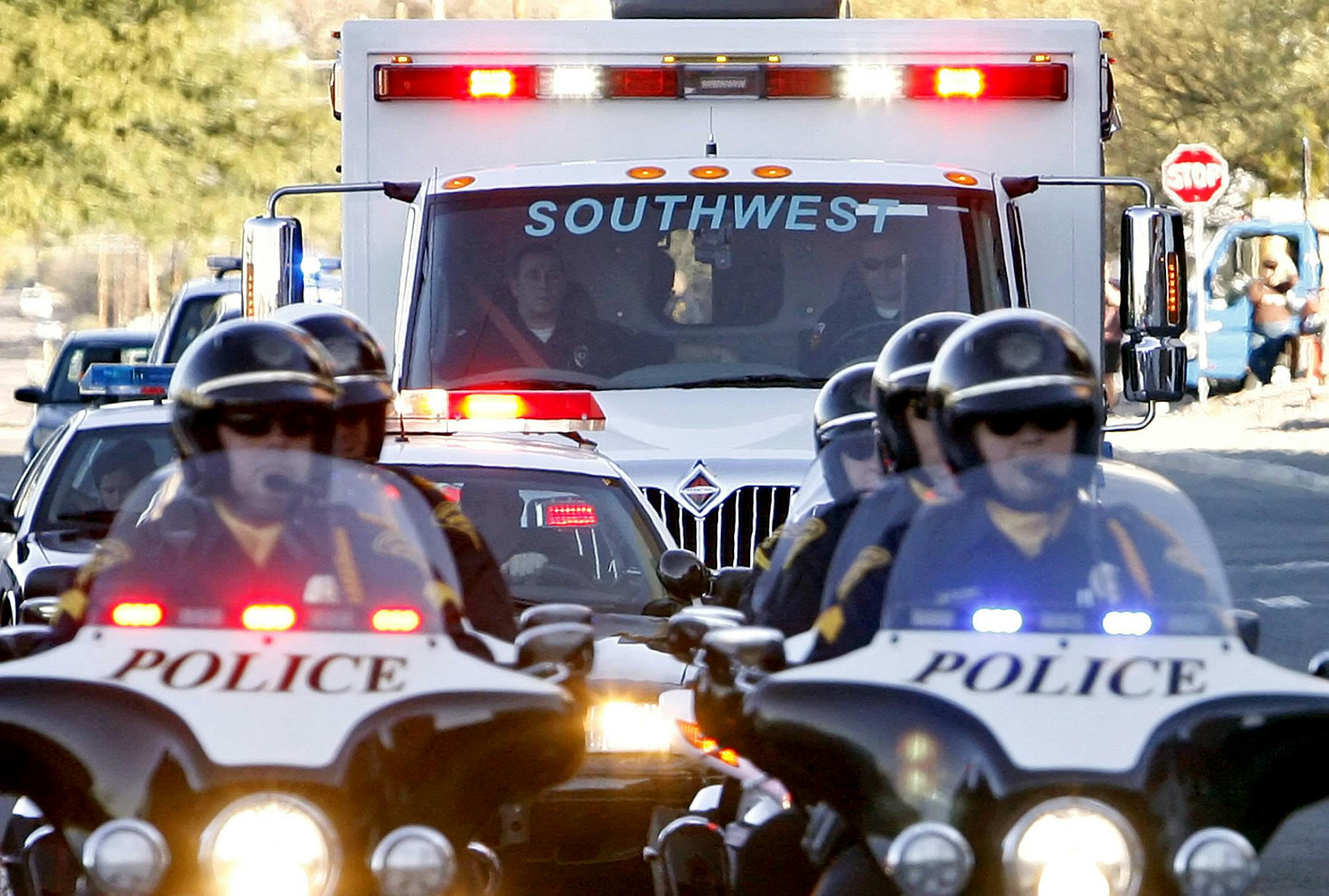 The ambulance carrying Rep. Gabrielle Giffords, D-Ariz., leaves University Medical Center behind a police escort in Tucson, Ariz., Friday, Jan. 21, 2011. Giffords is being moved Houston for further rehabilitation. It's the first time Giffords left the Tucson hospital since she was brought there with a gunshot wound to the head.