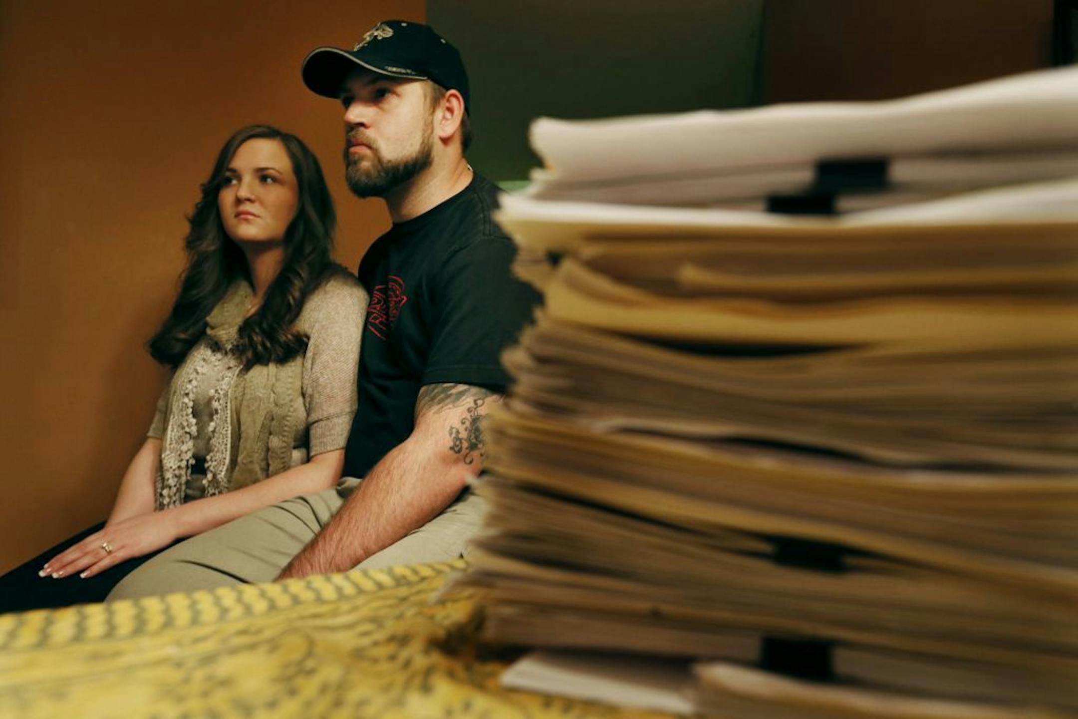 Sarah Hackbarth, with her husband, Jake, compiled a stack of medical records from pain treatments even before she received contaminated steroids.