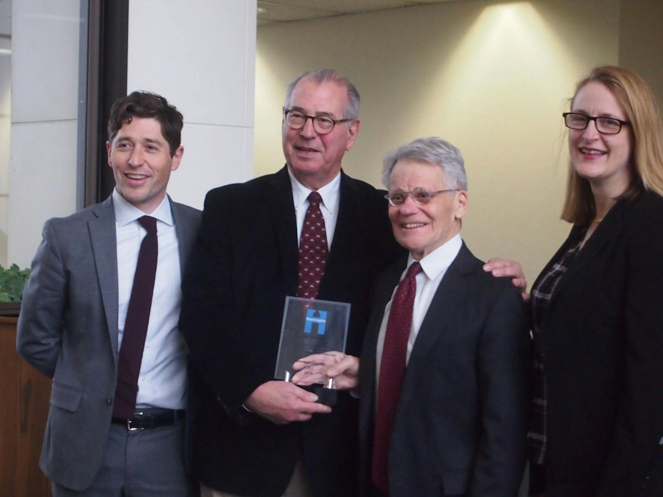 From left, Minneapolis Mayor Jacob Frey, Hennepin County Attorney Mike Freeman, Tom Johnson and Hennepin County Commissioner Marion Greene as Johnson was presented with the first Criminal Justice Coordinating Committee Customer Service Award.