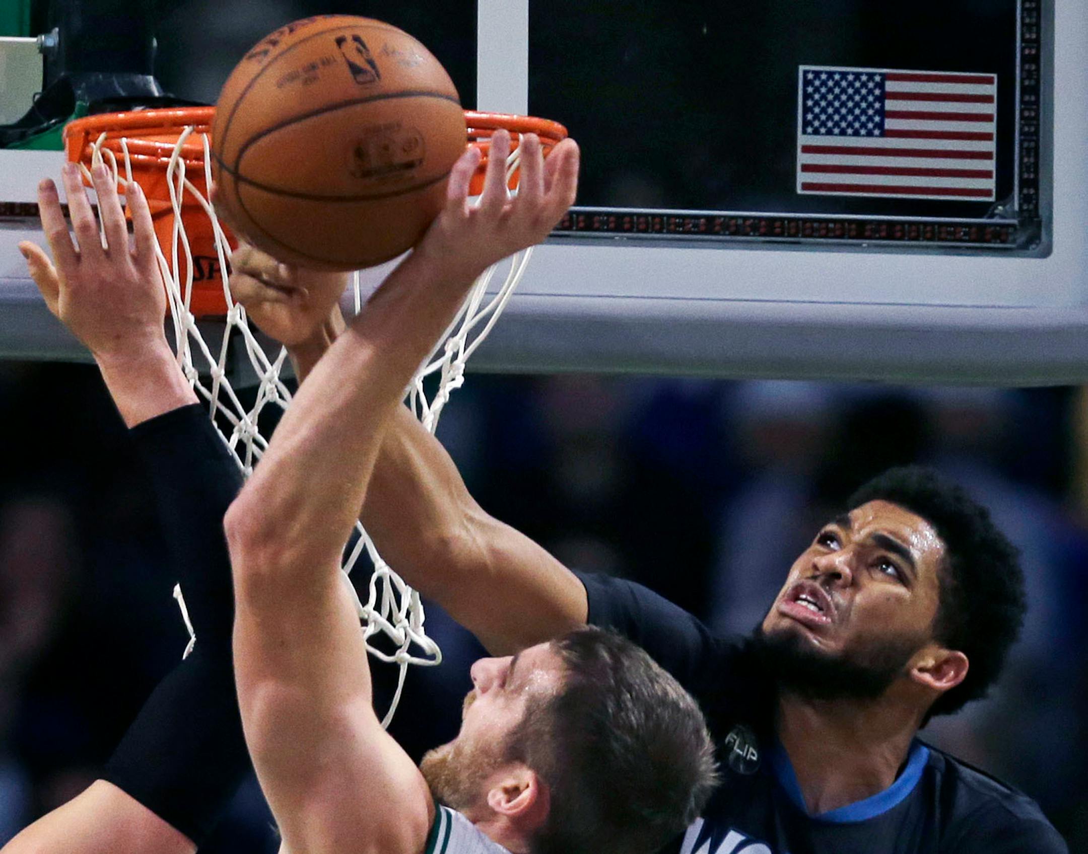 Timberwolves center Karl-Anthony Towns, right, knockws the ball away from Boston center Tyler Zeller on Monday.