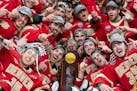 The Denver Pioneers pose for a photo with the NCAA Championship trophy after defeating Boston College 2-0 in the Frozen Four title game Saturday night