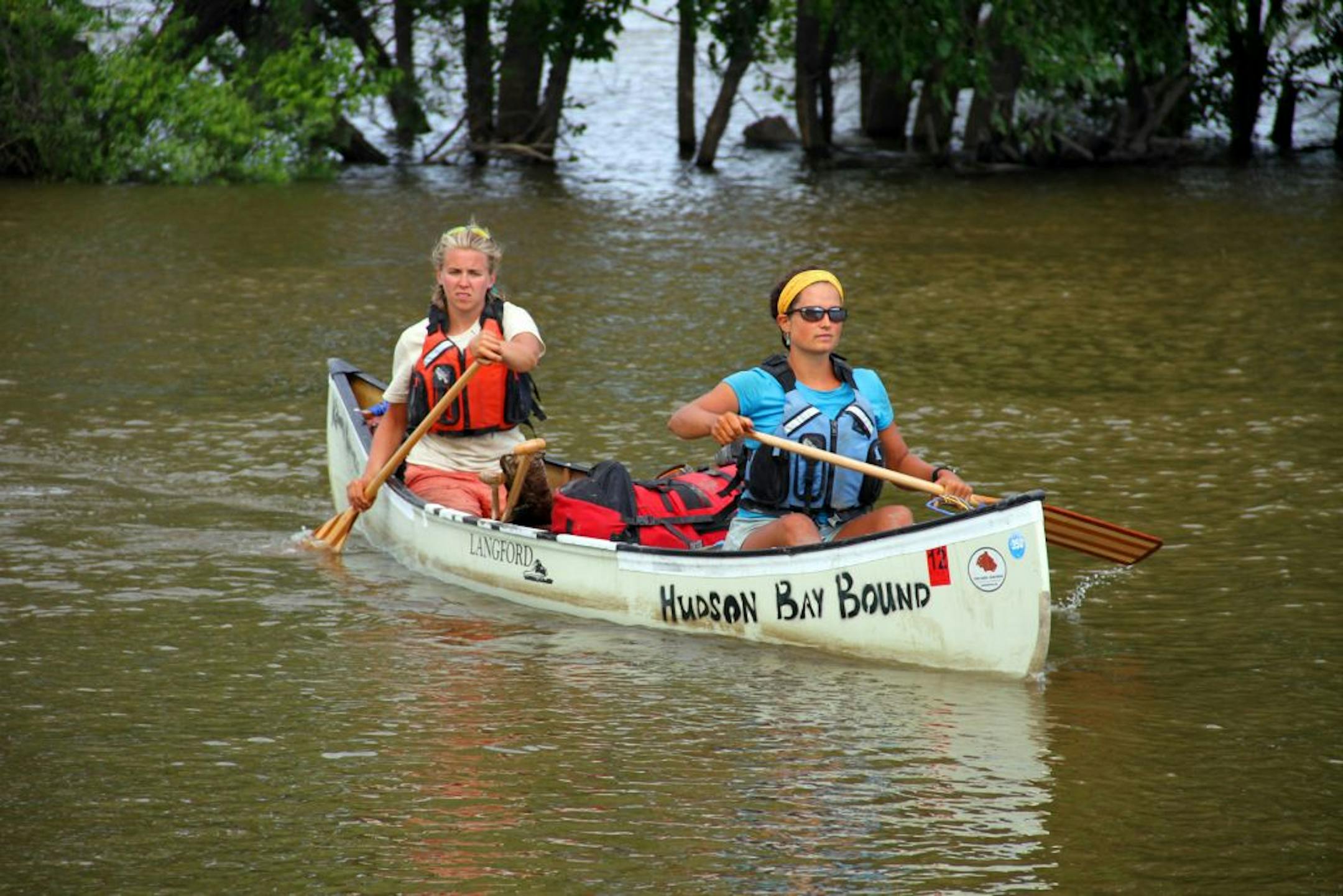 Heading to the riverbank of a flood-swollen Red River, the pair have had a long day of paddling, covering more than 30 miles one day last week from Drayton, N.D., to Pembina, N.D.