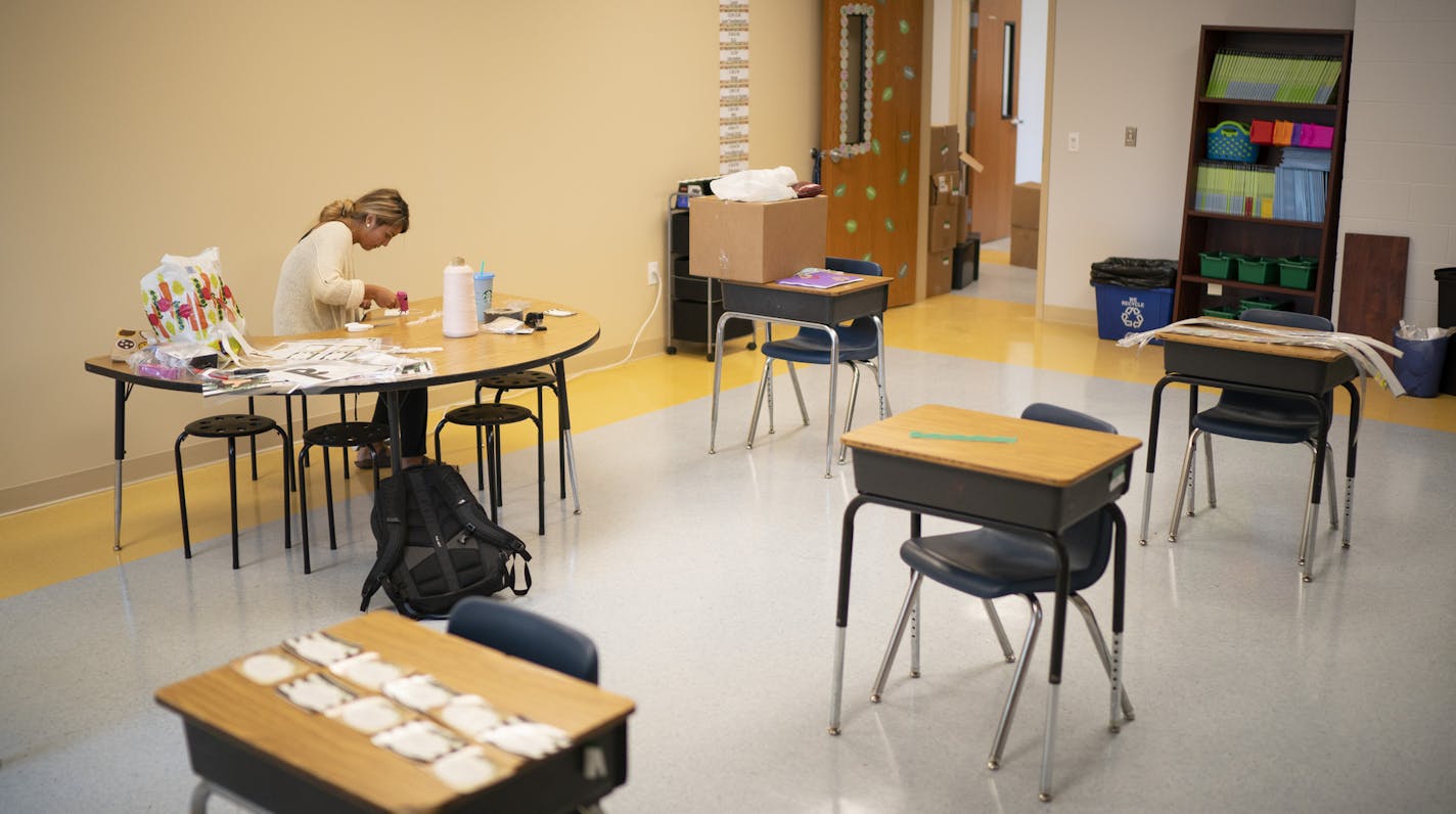 At Friendship Academy of the Arts, fourth-grade teacher Angelica Martinez spaced out desks and prepared to teach both kids in the school and virtually to students at home. Construction crews are finishing the last work on Friendship Academy of the Arts' new building, as teachers prepare their classrooms Wednesday, Aug. 26, in Minneapolis.