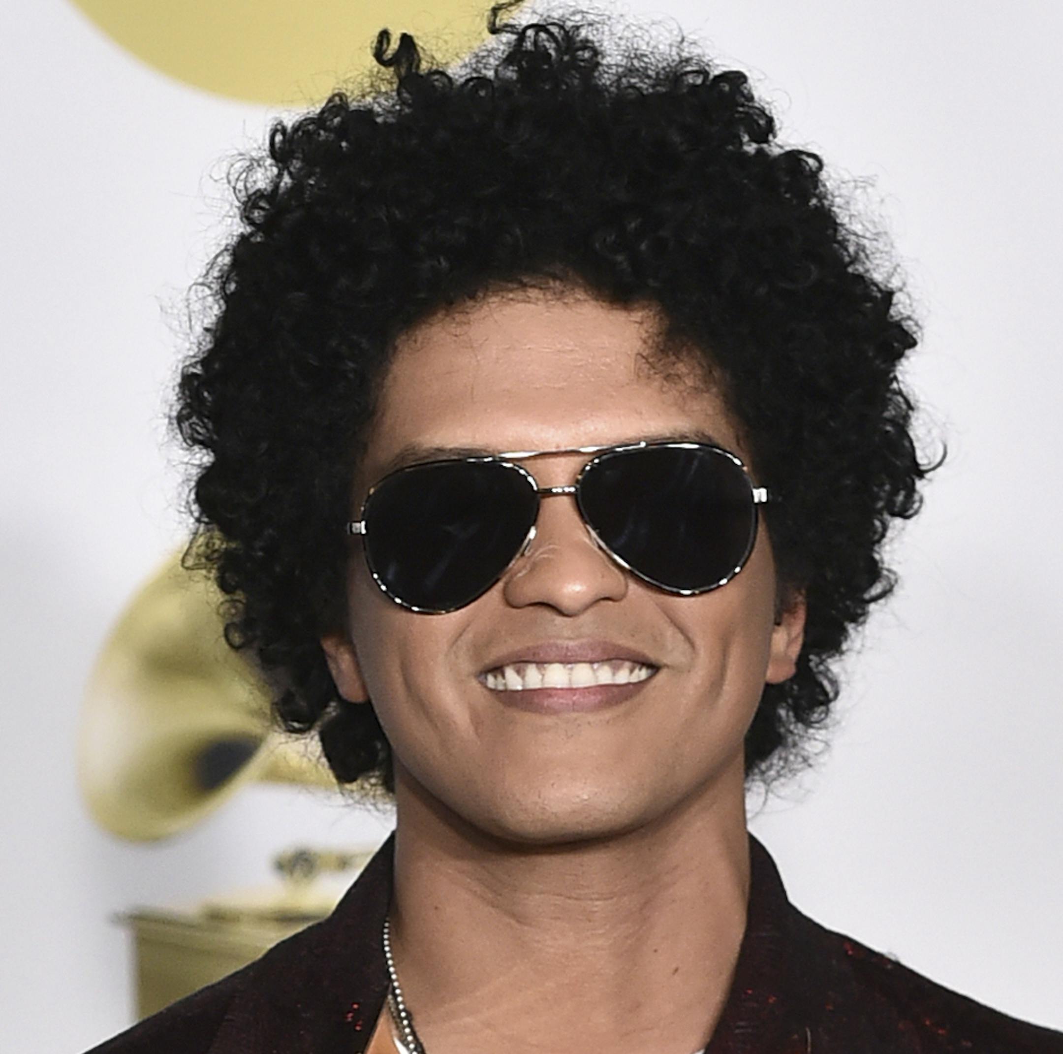 Bruno Mars poses in the press room with his awards for best R&B album, record of the year, album of the year, best engineered album, non-classical, for "24K Magic," and song of the year, best R&B performance and best R&B song, for "That's What I Like" at the 60th annual Grammy Awards at Madison Square Garden on Sunday, Jan. 28, 2018, in New York. (Photo by Charles Sykes/Invision/AP)