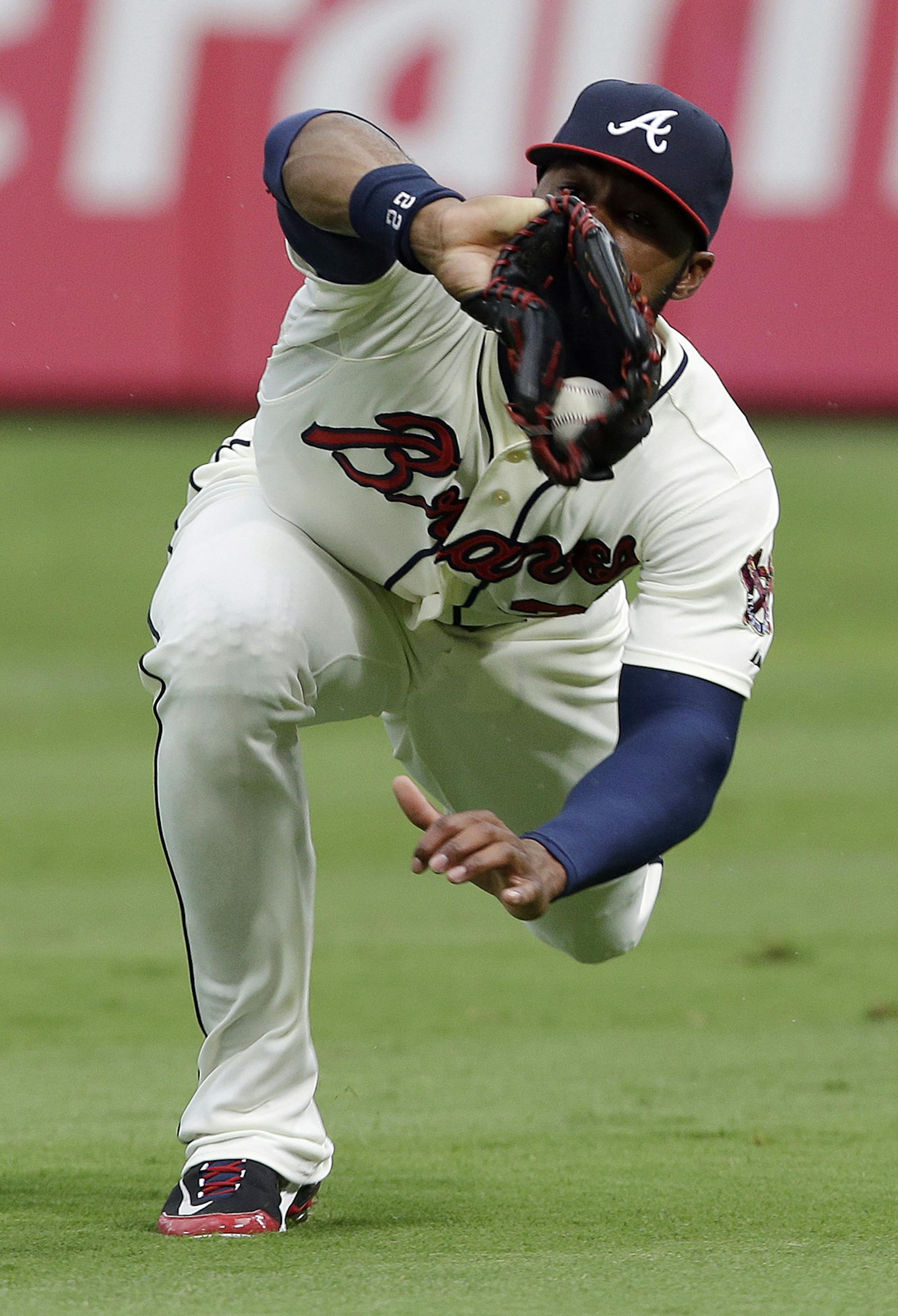 Atlanta Braves right fielder Jason Heyward makes a diving catch to retire Miami Marlins' Adeiny Hechavarria in the first inning of a baseball game in Atlanta, Saturday, Aug. 10, 2013. (AP Photo/John Bazemore) ORG XMIT: GAJB101