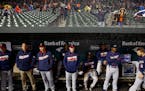 Minnesota Twins manager Paul Molitor, center, stands in the dugout during a rain delay in the Twins' baseball game against the Baltimore Orioles in Ba