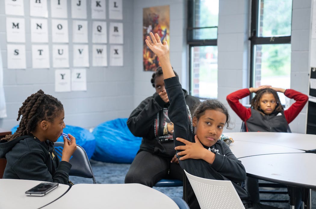 Christian, aka “Blaze,” a sixth-grade student, raises his hand to answer a question during group activity time at the Phelps Recreation Center in Minneapolis on Friday.