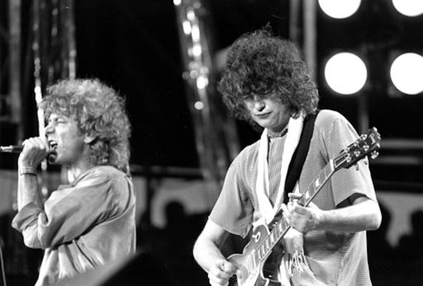 FILE - In this July 13, 1985 file photo, singer Robert Plant, left, and guitarist Jimmy Page of the British rock band Led Zeppelin perform at the Live Aid concert at Philadelphia's J.F.K. Stadium. Generations of aspiring guitarists have tried to copy the riff from Led Zeppelin's "Stairway to Heaven." Starting Tuesday, June 14, 2016, a Los Angeles court will try to decide whether the members of Led Zeppelin themselves ripped off that riff. Page and Plant are named as defendants in the lawsuit bro