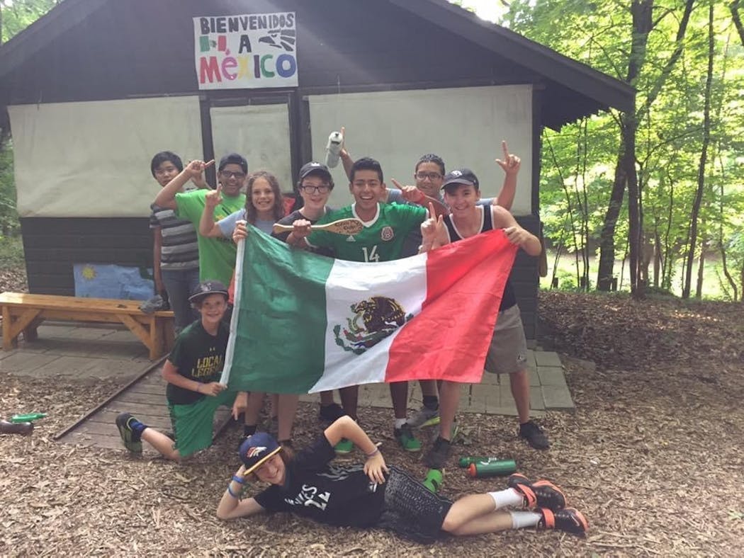 Camp counselor Lalo Edmondson, center, wearing green jersey, posed with his campers for a picture during 