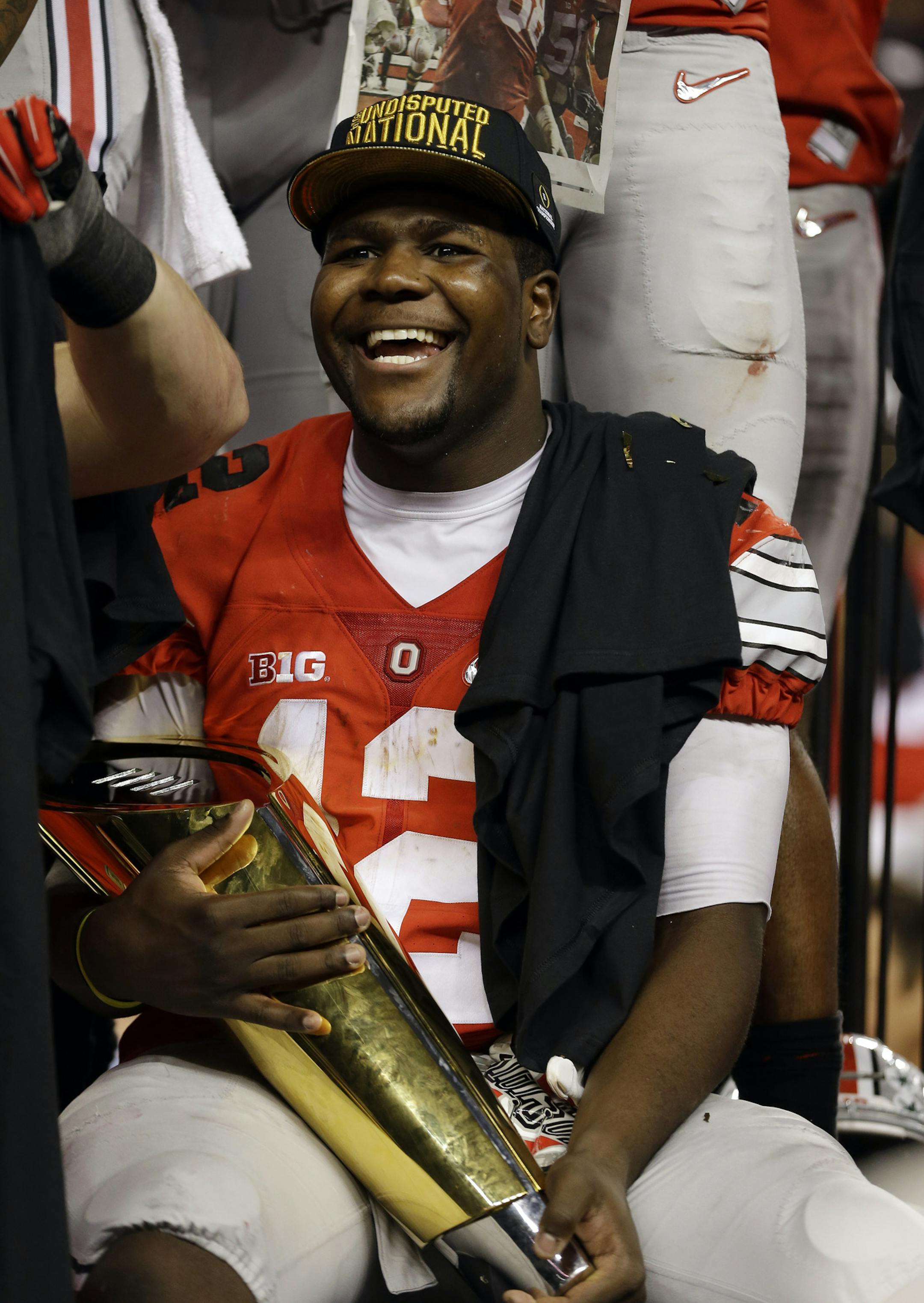 Ohio State's Cardale Jones holds the championship trophy after the NCAA college football playoff championship game against Oregon Monday, Jan. 12, 2015, in Arlington, Texas. Ohio State won 42-20. (AP Photo/David J. Phillip)