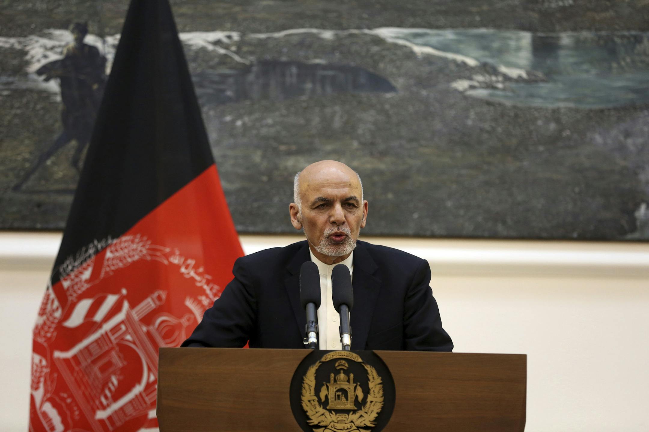 FILE - In this March 26, 2019 photo, Afghan President Ashraf Ghani speaks during a press conference with European Union foreign policy chief Federica Mogherini at the presidential palace in Kabul, Afghanistan. Ghani is hosting a grand council of some 2,500 prominent figures to agree on a shared approach to peace talks with the Taliban. But the gathering instead looks to further aggravate divisions within the U.S.-backed government, even as America makes progress with the insurgents in direct tal