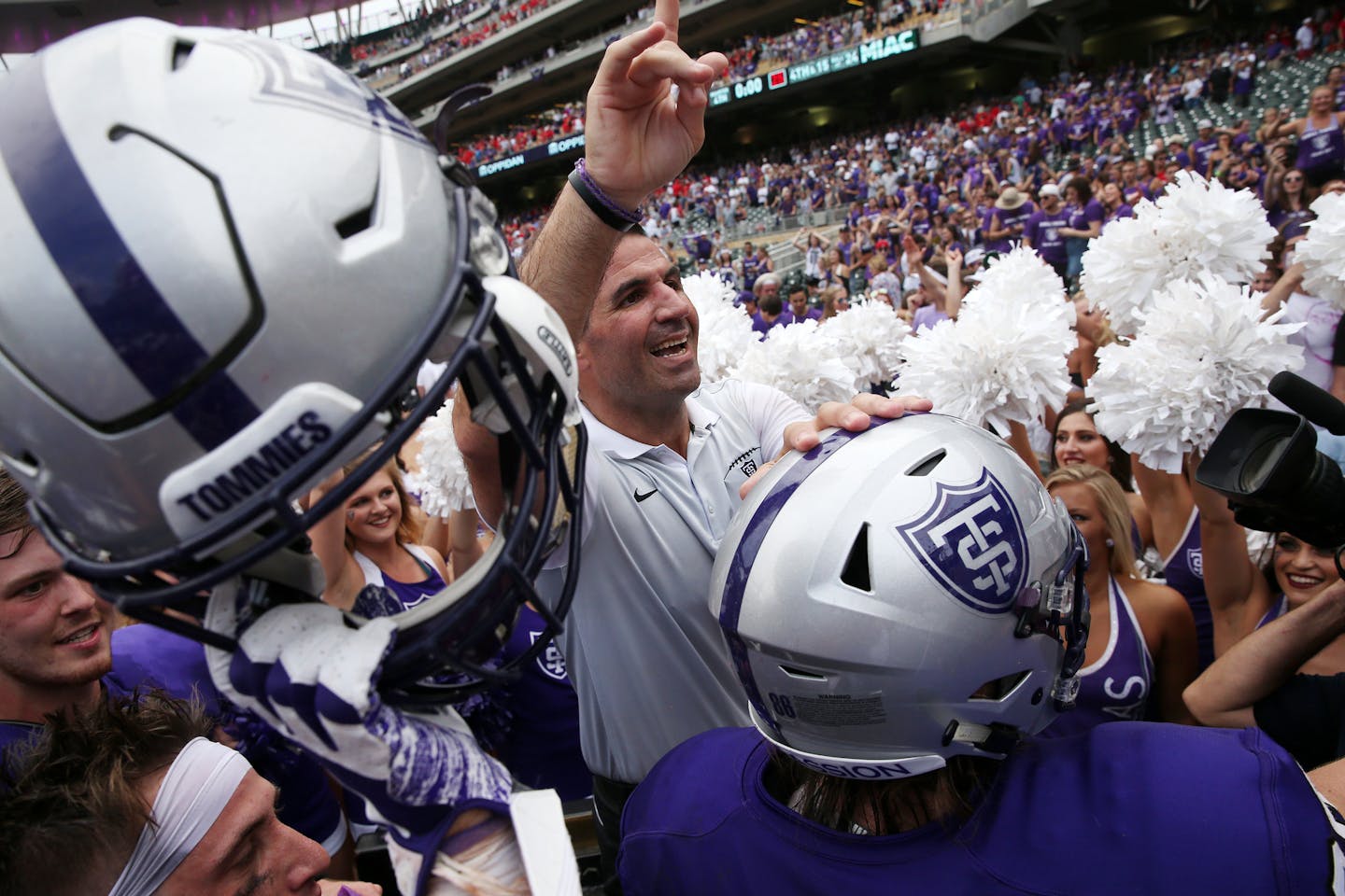 University of St. Thomas head coach Glenn Caruso celebrated with his team after the win. ] ANTHONY SOUFFLE &#x2022; anthony.souffle@startribune.com Game action from an NCAA football game between the University of St. Thomas and St. John's University Saturday, Sept. 23, 2017 at Target Field in Minneapolis.