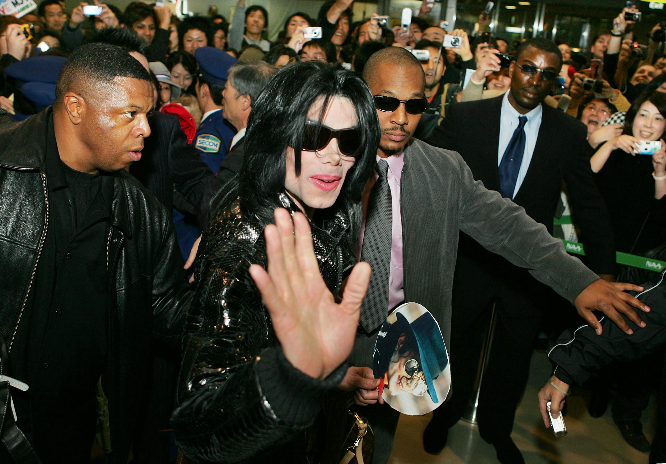 In this file photo, U.S. pop star Michael Jackson waves to fans on his arrival at Narita international airport, near Tokyo, Sunday, March 4, 2007.