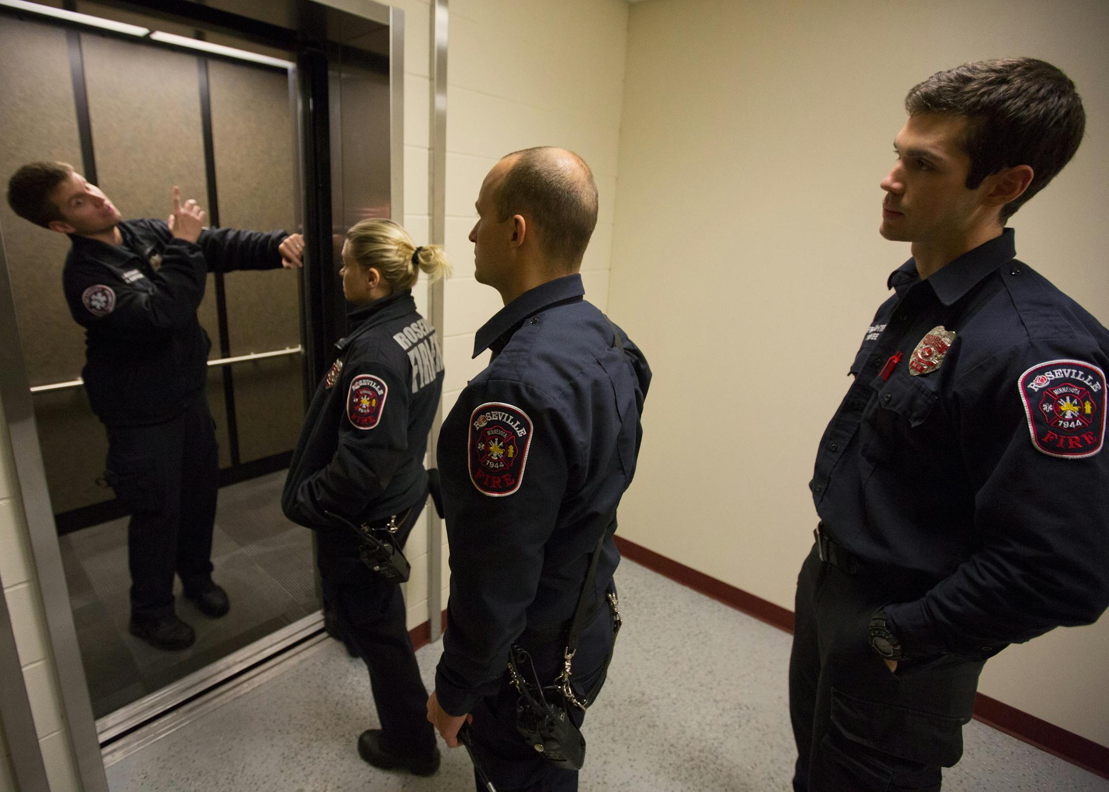 Firefighter Neil Sjostrom (left) leads a elevator rescue training session at the Roseville fire station with firefighters Erin Stone, Anton Fehrenbach and Patrick McKee. ] BRIAN PETERSON ‚Ä¢ brian.peterson@startribune.com Roseville, MN 11/04/14