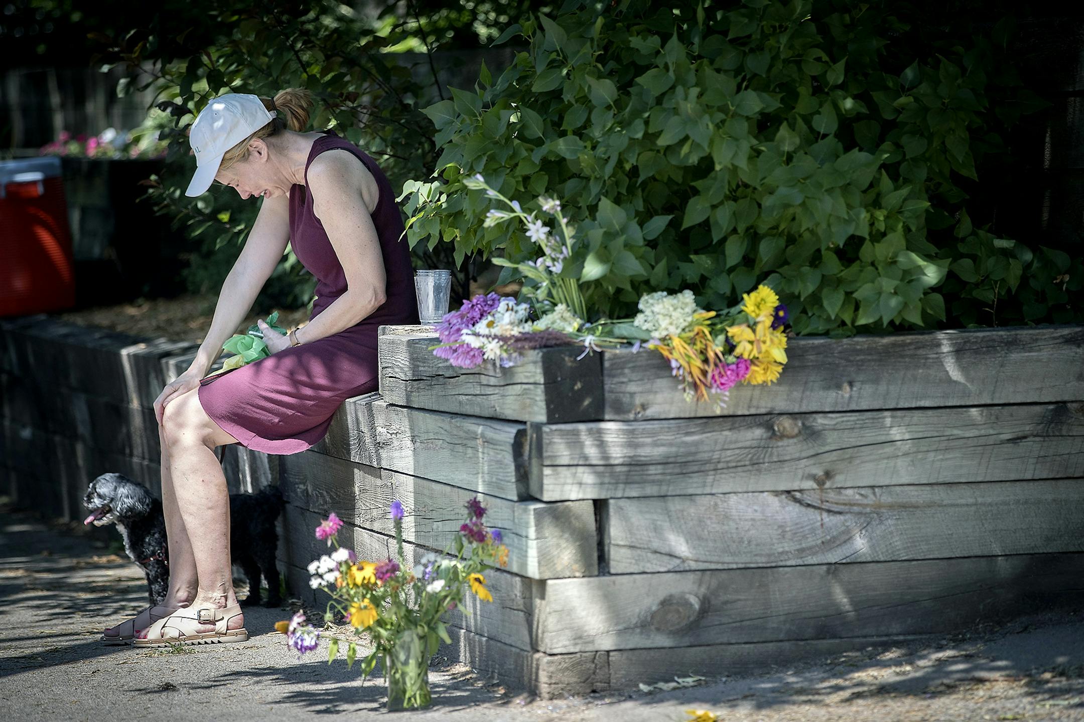 "She (Justine) was the bright light the world needed today," cried out friend Denise Houser as she visited the makeshift memorial that was left at the scene where a Minneapolis police officer shot and killed Justine Damond, Monday, July 17, 2017 in Minneapolis, MN.