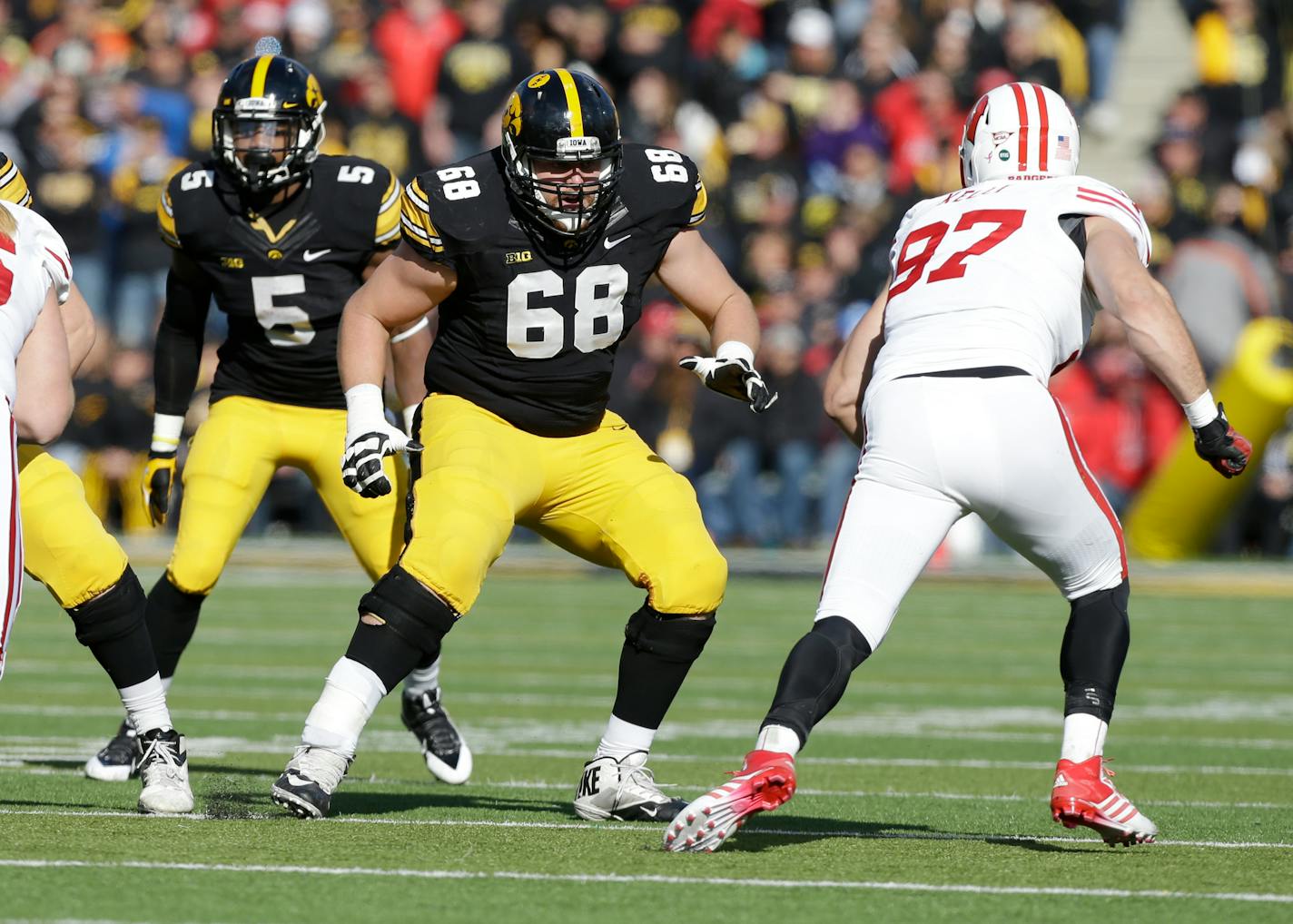 Iowa offensive lineman Brandon Scherff (68) looks to block Wisconsin linebacker Brendan Kelly, right, during the first half of an NCAA college football game, Saturday, Nov. 2, 2013, in Iowa City, Iowa. (AP Photo/Charlie Neibergall)