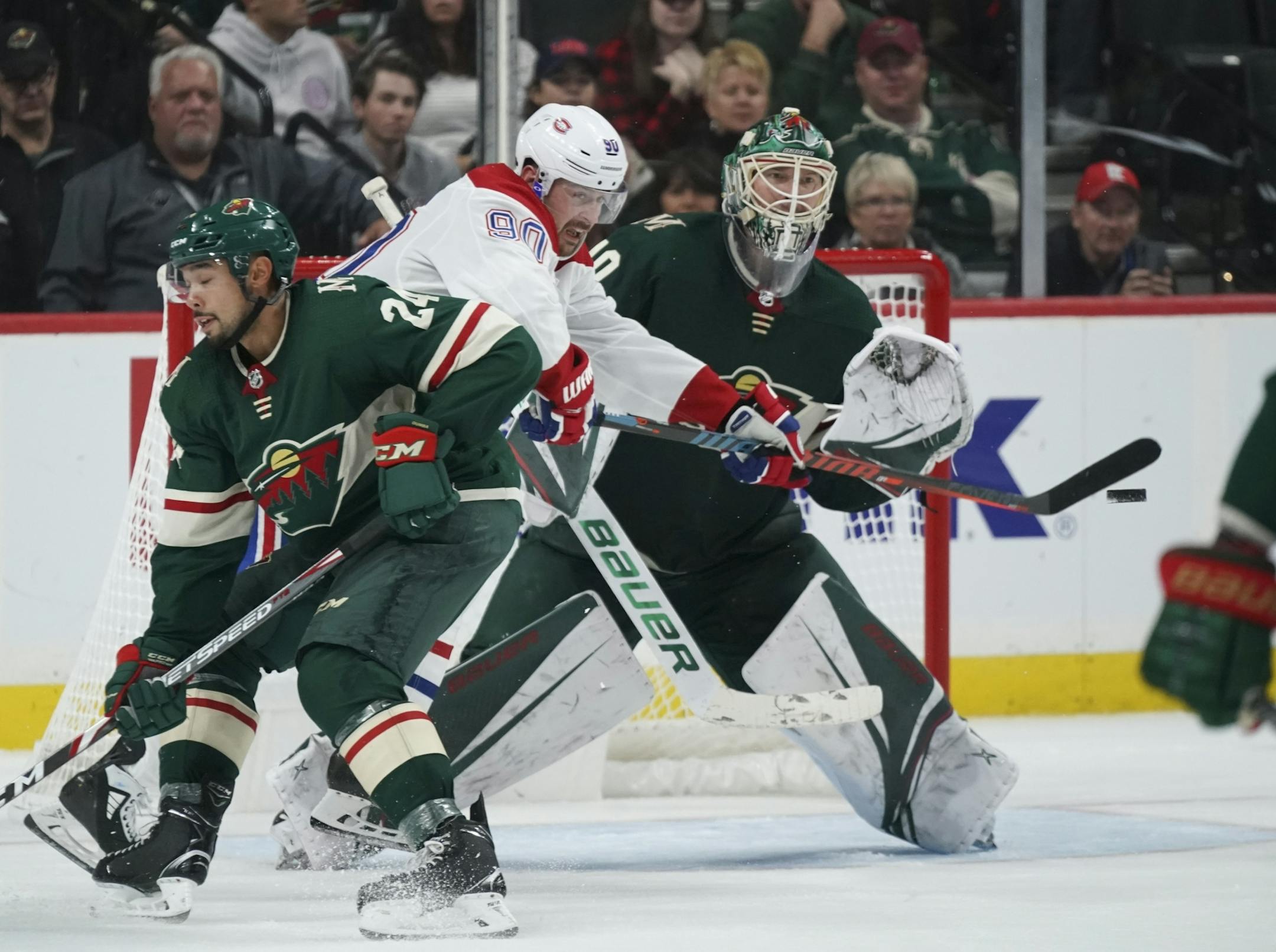 Montreal Canadiens left wing Tomas Tatar (90) tried to deflect an incoming puck in front of Minnesota Wild goaltender Devan Dubnyk (40) while Matt Dumba (24) defended.