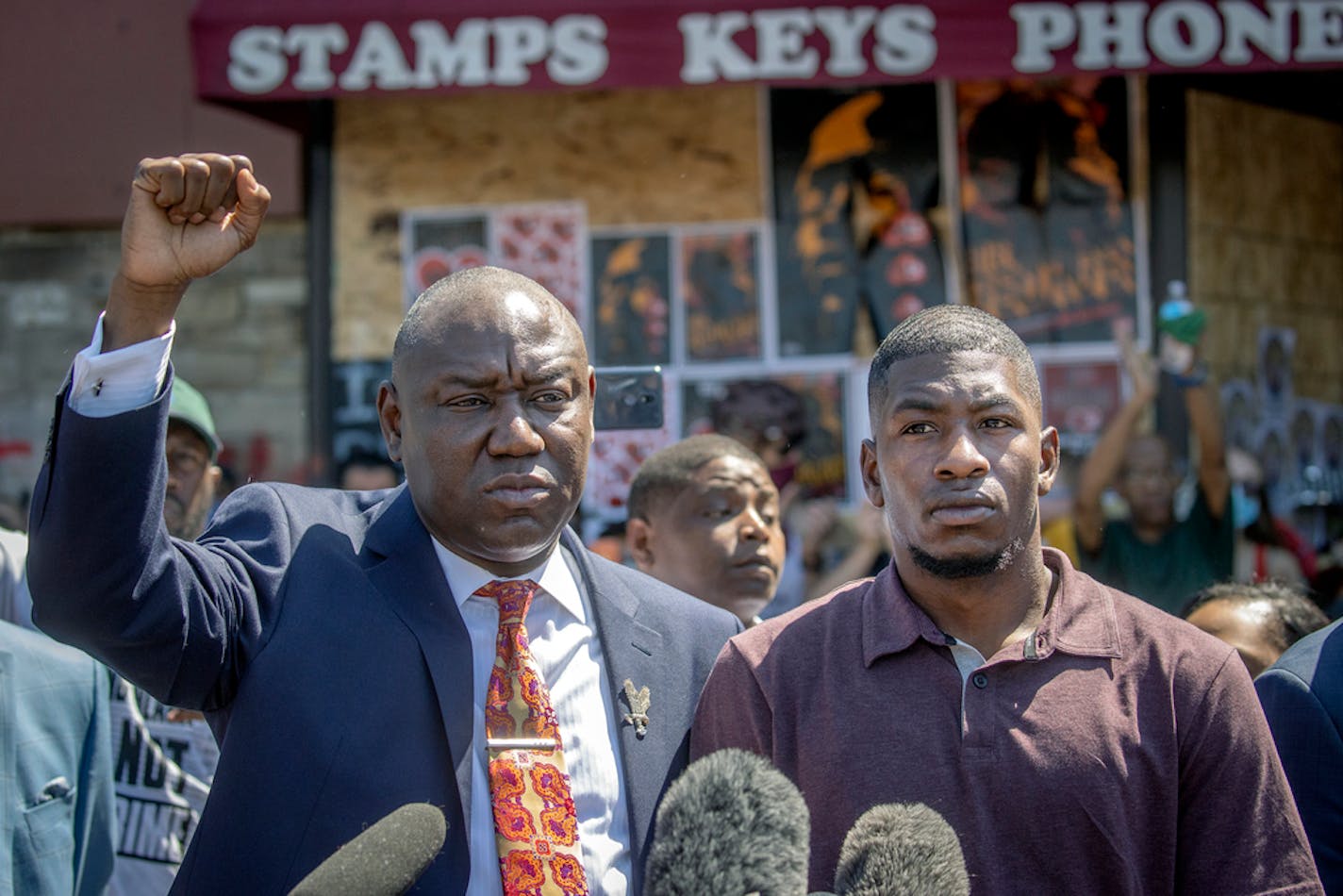 Attorney Ben Crump, left, stood with George Floyd's son Quincy Mason as they addressed the media Wednesday at Cup Foods in Minneapolis.