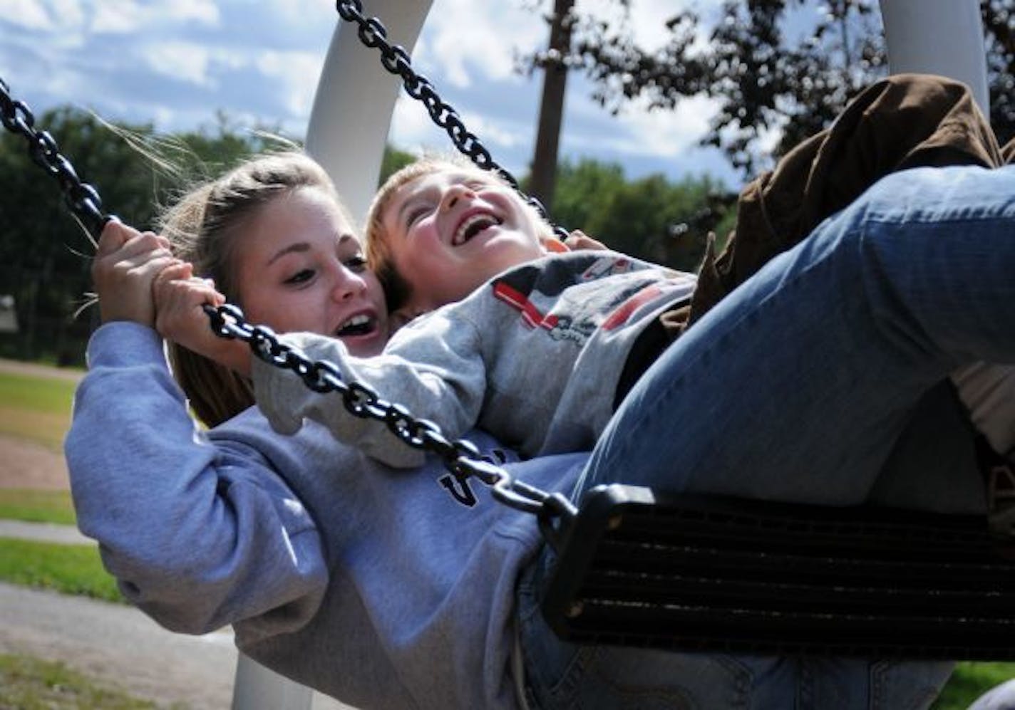 Morgan Baumgarten, a student at Augsburg, with Gil Bergin, 5, on the playground at Matthews Community Center.