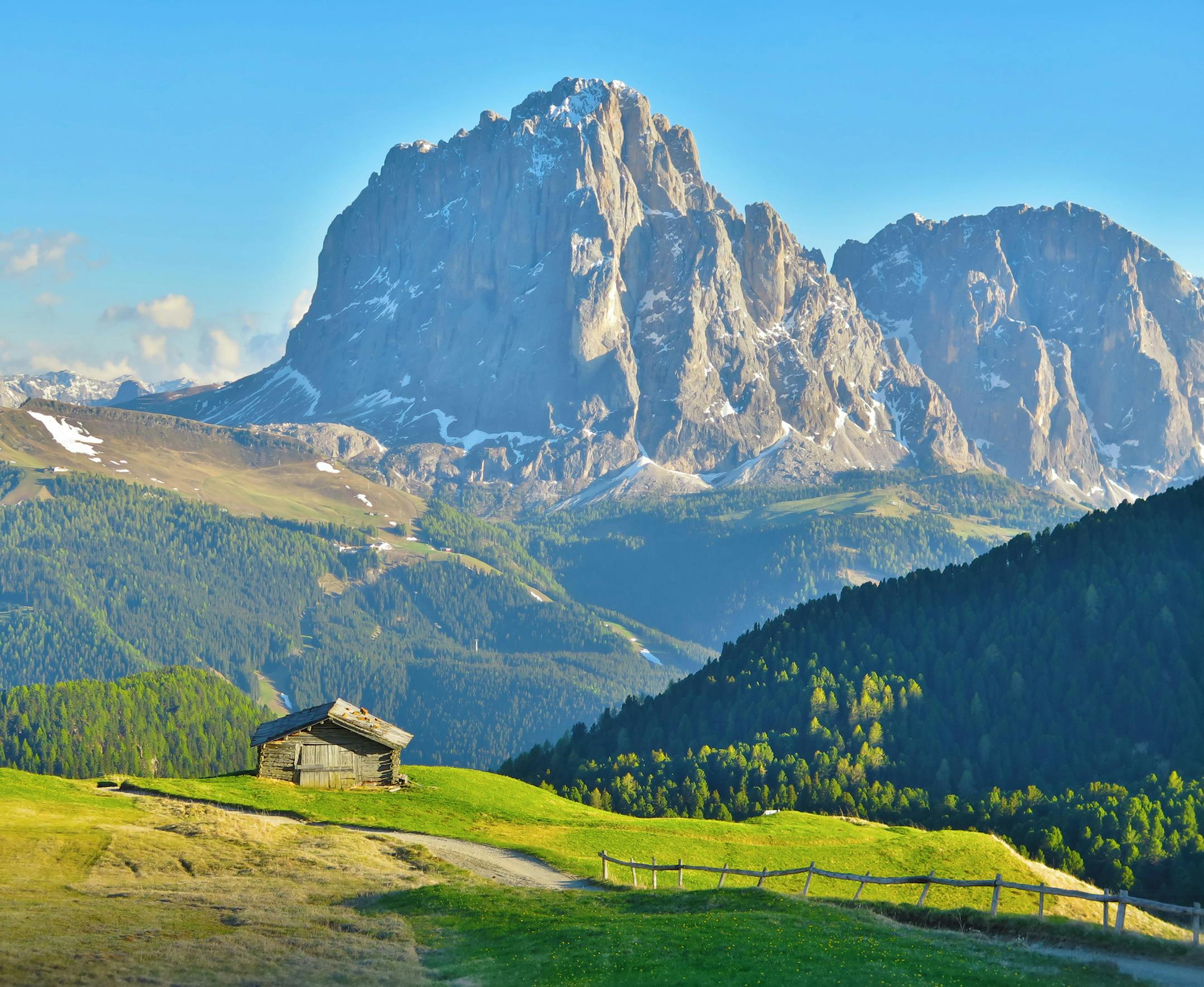 This photo was taken from the Alpe di Seceda, or Seceda, in the Dolomites mountain range. The Seceda in itself is an impressive landform; however, the photo shows a wooden h¸tte with the Sassolungo Langkofel mountain as the backdrop. Nestled in the valley between the hut and the mountain is the town of Santa Cristina GherdÎina. What equipment did you useóa phone or a particular camera? Canon G16 camera. HDR setting. How did you get this shot? Did you employ any particular techniqu