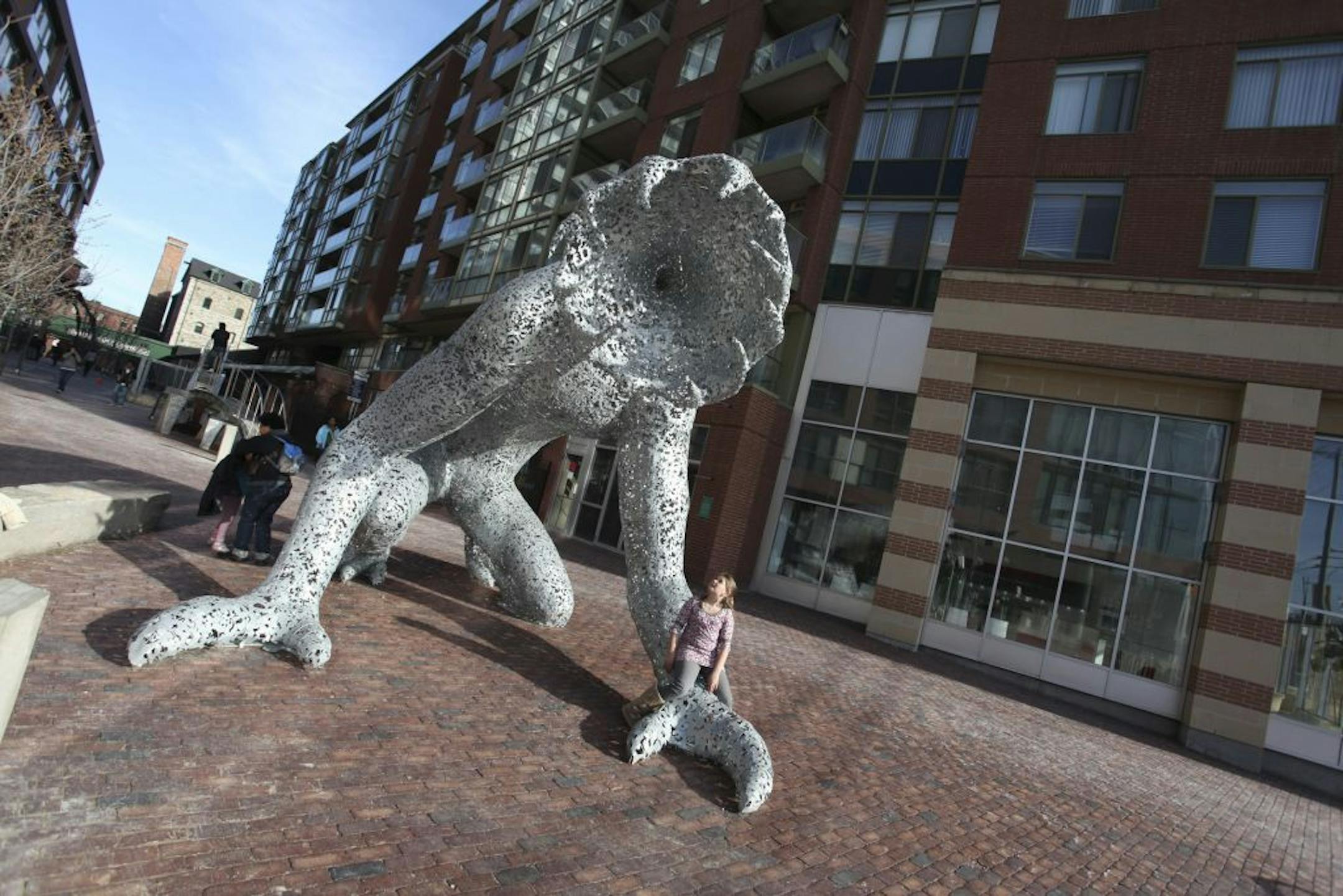 The 14-foot metal sculpture "Koilos," lords over Distillery Lane. Victorian industrial architecture is a hallmark of Toronto's Distillery District, which draws art enthusiasts, shoppers and diners.