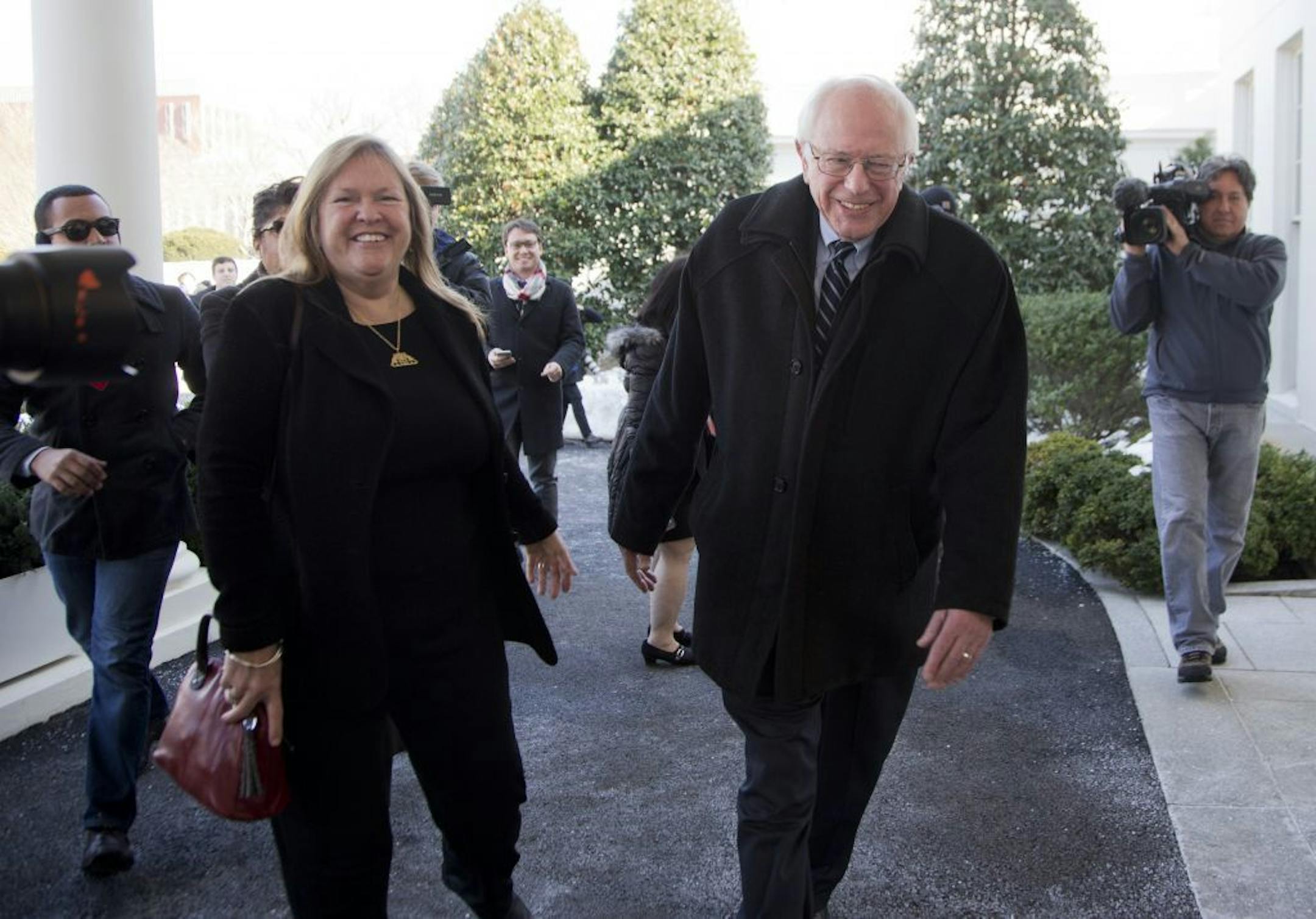 Democratic presidential candidate Sen. Bernie Sanders, I-Vt., with his wife Jane Sanders, walk away after speaking to reporters outside the White House in Washington, Wednesday, Jan. 27, 2016, following a meeting with President Barack Obama.