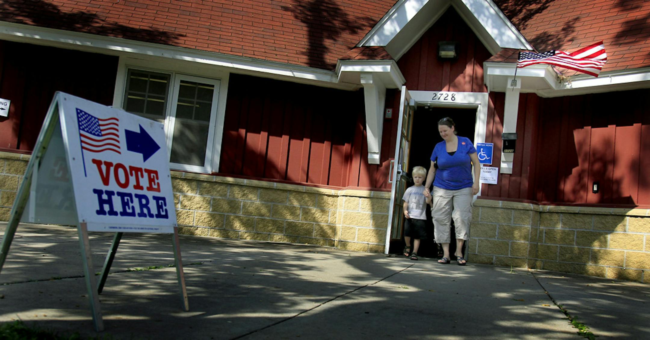 Sarah Wernimont made her way out of of the Brackett Park Pavillion after voting with her sons, Leo, 4, and August, 7, not shown, Tuesday in Minneapolis.