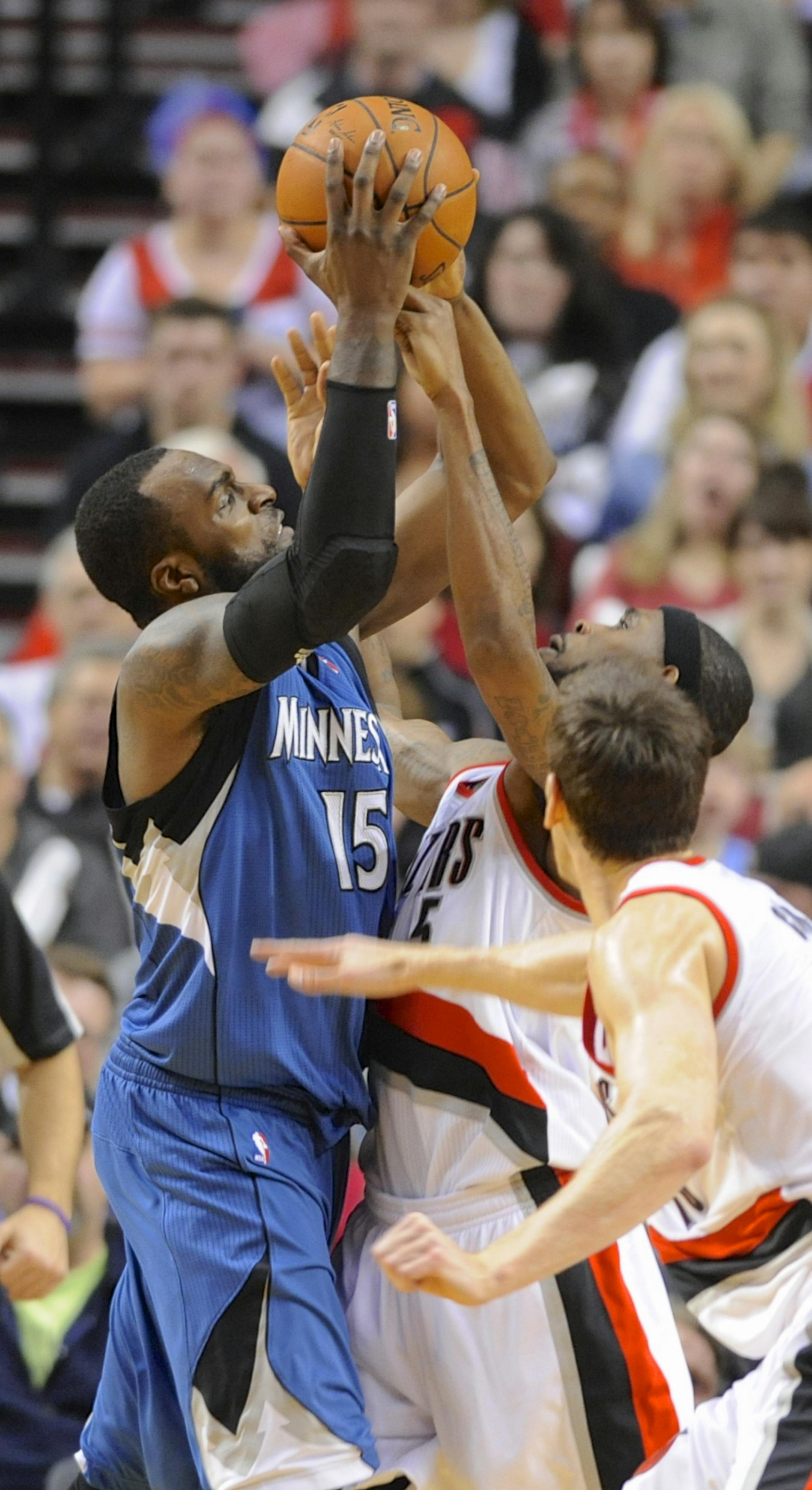 Portland Trail Blazers' Will Barton (5) defends against Minnesota Timberwolves' Shabazz Muhammad (15) during an NBA basketball game in Portland, Ore., Sunday Feb. 23, 2014. (AP Photo/Greg Wahl-Stephens)