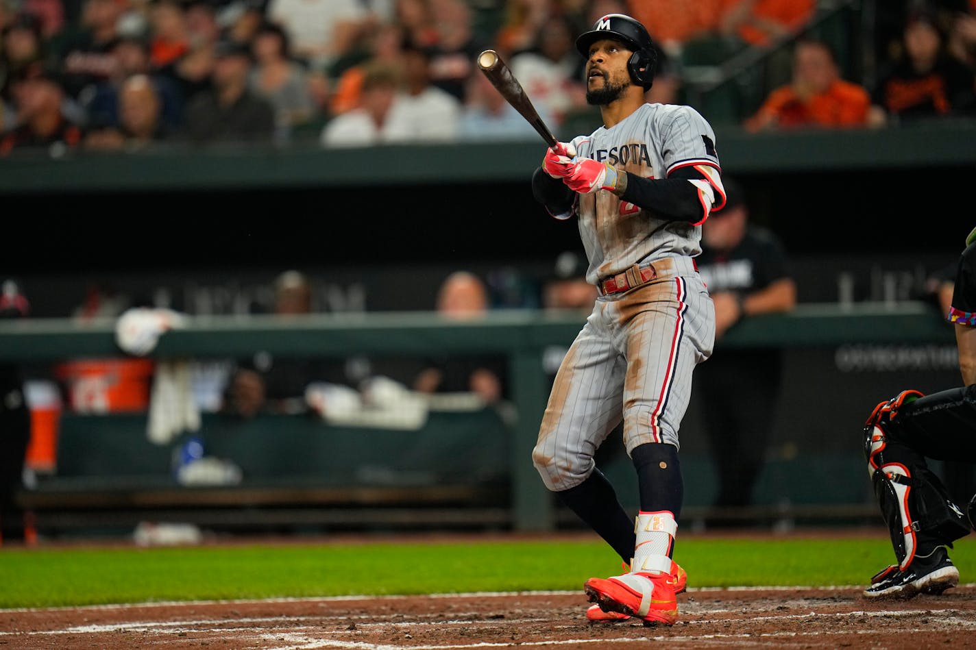 Minnesota Twins' Byron Buxton watches his ball as he hits a three-run home run off Baltimore Orioles relief pitcher Bruce Zimmermann during the fourth inning of a baseball game, Friday, June 30, 2023, in Baltimore. Twins' Joey Gallo and Carlos Correa scored on the home run. (AP Photo/Julio Cortez)