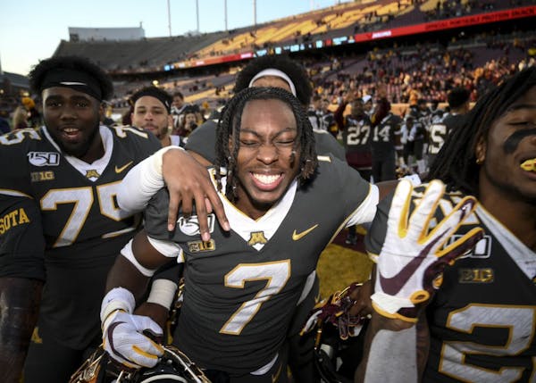 Gophers defensive back Solomon Brown (7) celebrated with teammates following their team's 52-10 win over Maryland.