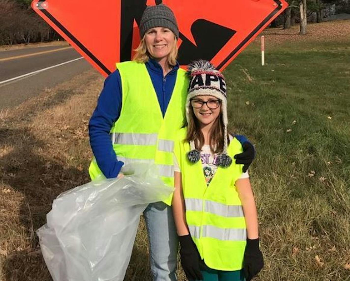 Young Jayna Kelley, with her mother, Robin Kelley, a teacher at Jayna's elementary school, during the roadside cleanup on Saturday. The photo was taken just minutes before the crash, Robin Kelley said.