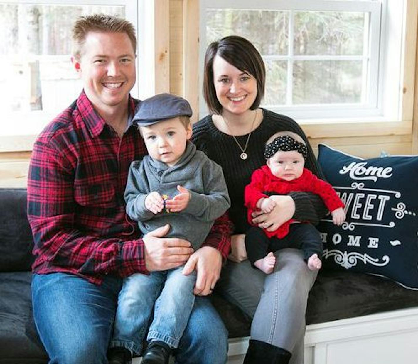 Zac and Caitlin with their children inside their tiny house