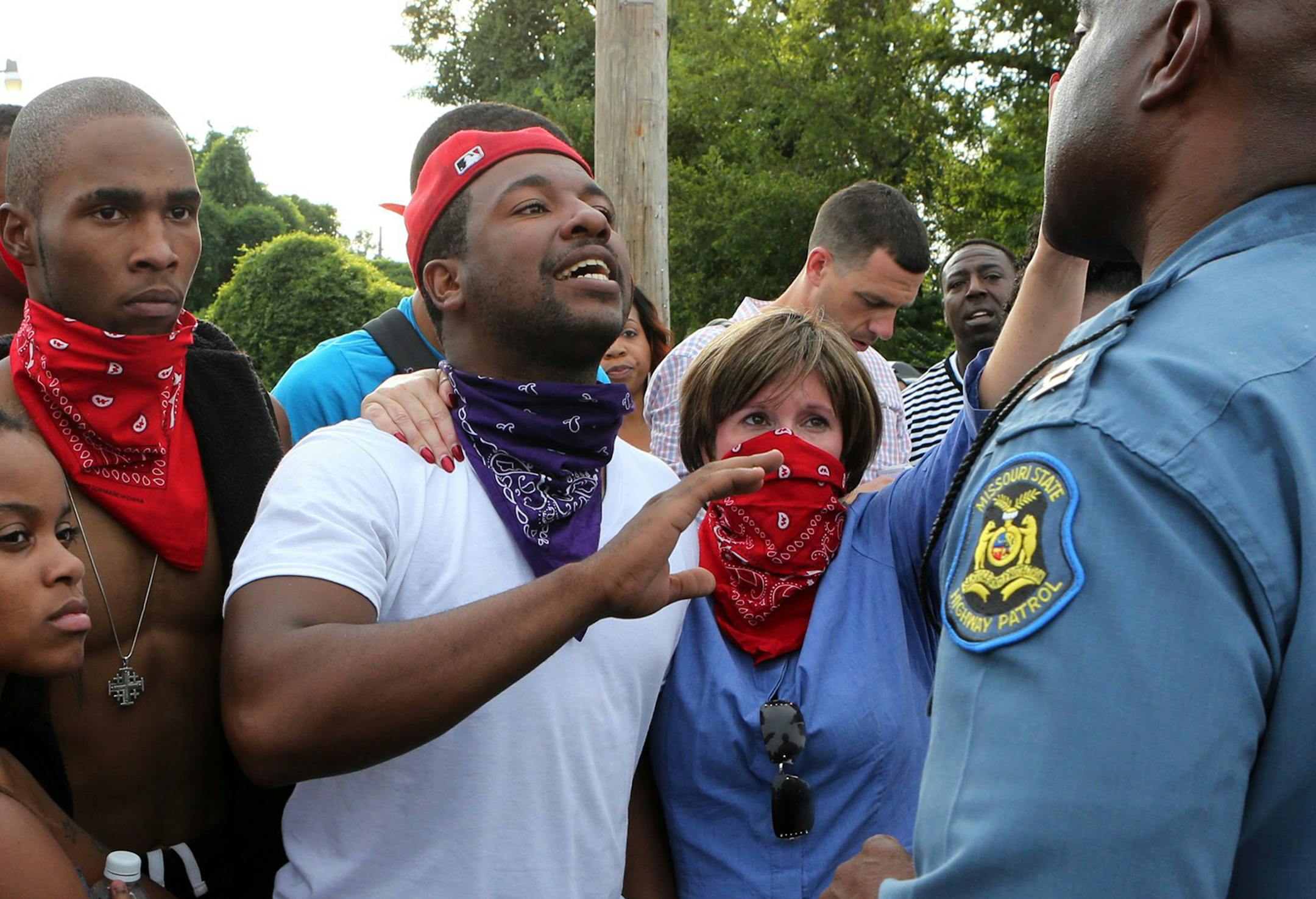 Pastor Renita Lamkin of St. Johns AME Church, second from right, joins the protesters who confronted Missouri Highway Patrol Col. Ron Johnson in Ferguson, Mo., on Aug. 14, 2014, with questions about the shooting of Michael Brown. (J.B. Forbes/St. Louis Post-Dispatch/MCT) ORG XMIT: 1159679