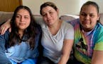 Daysi Villalobos Izagguire, sitting between daughters Kerlin Sanchez Villalobos, left, and Y.S., who is only referenced in the lawsuit by her initials