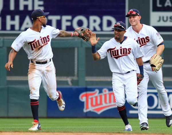 Minnesota Twins outfielders Byron Buxton (25), Eddie Rosario (20) and Max Kepler (26) celebrate after defeating the Texas Rangers during a baseball ga