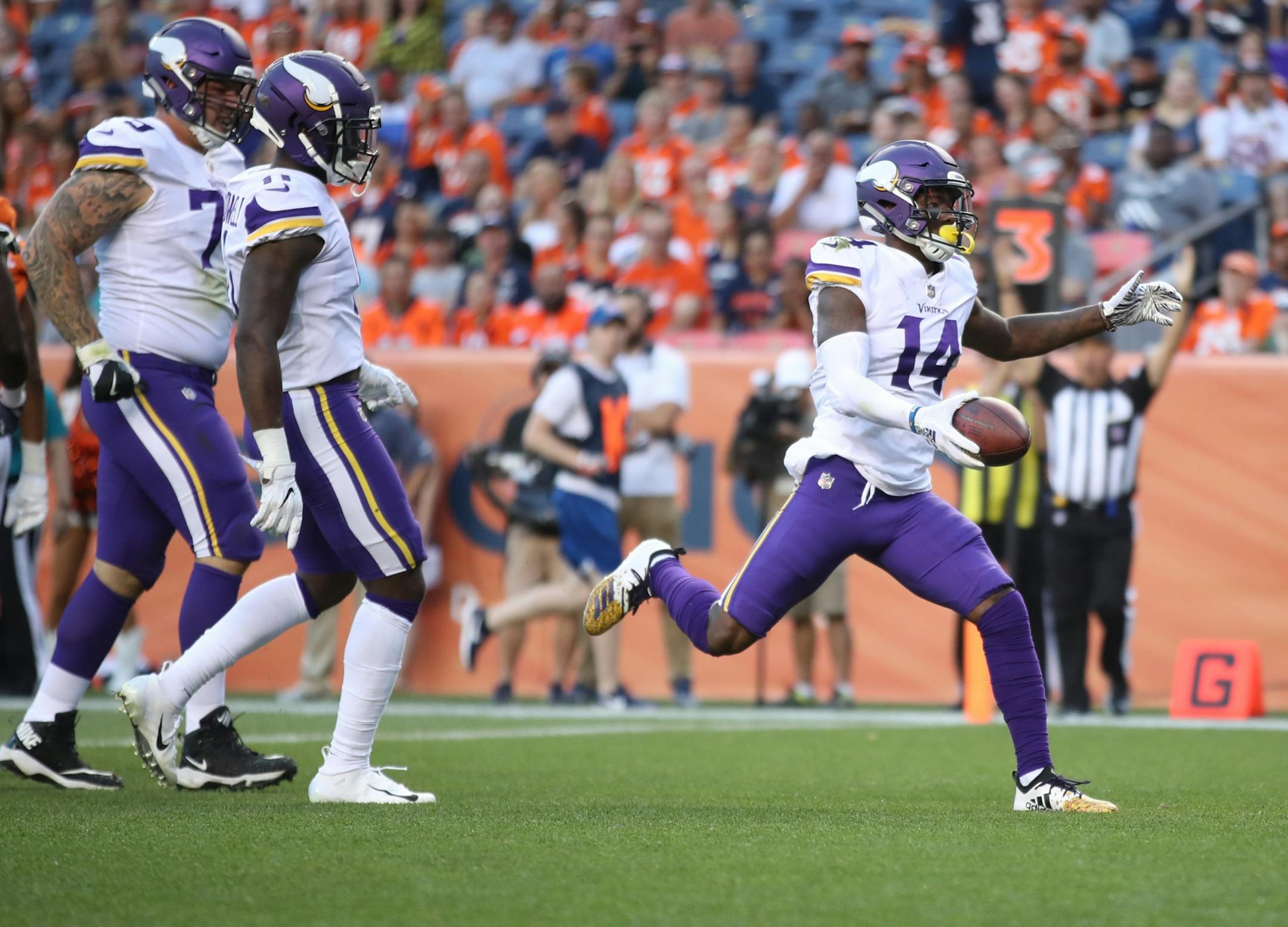 Minnesota Vikings wide receiver Stefon Diggs (14) faked a punt kick during his first quarter celebration Saturday August 11, 2018 at Mile High Stadium in Denver, CO.