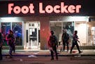 Crowds clashed with police, smashed windows and looting occurred in downtown Minneapolis on Wednesday night.