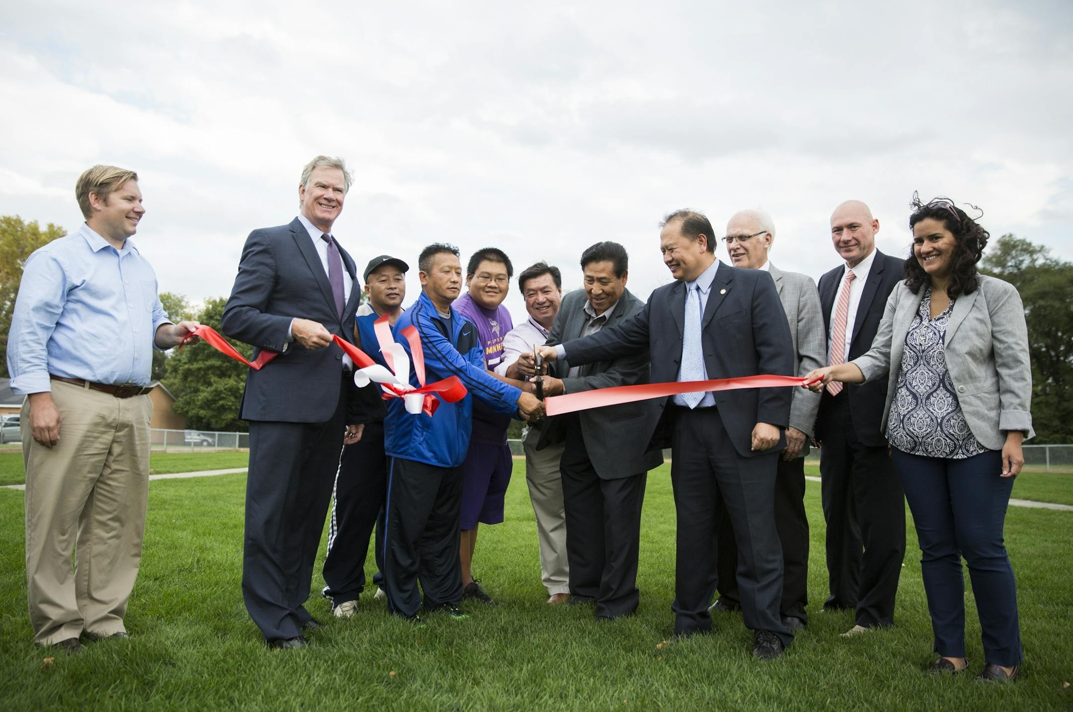 City and state officials join community members and Tuj Lub players to cut the ribbon on the state's first Tuj Lub courts in St. Paul.