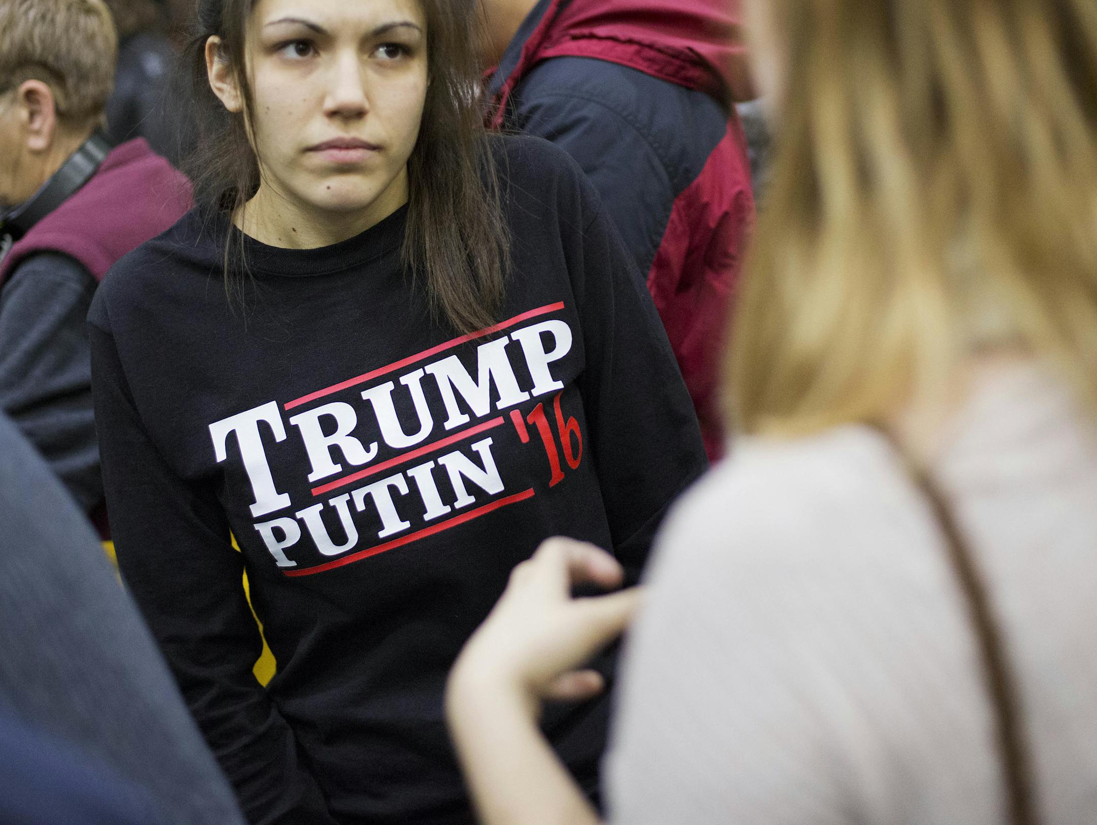 FILE - In this Sunday, Feb. 7, 2016 file photo, a woman wears a shirt reading 'Trump Putin '16' while waiting for Republican presidential candidate Donald Trump to speak at a campaign event at Plymouth State University in Plymouth, N.H. Donald Trump just keeps giving Russian President Vladimir Putin more reasons to hope he wins the U.S. election, while raising serious questions about the Republican candidateís intentions toward the Kremlin. ?In his most recent outreach to Putin, Trump not o