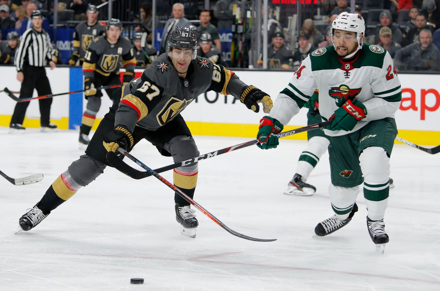 Vegas Golden Knights left wing Max Pacioretty (67) and Minnesota Wild defenseman Matt Dumba (24) vie for the puck during the second period of an NHL hockey game Tuesday, Dec. 17, 2019, in Las Vegas. (AP Photo/John Locher) ORG XMIT: NVJL114