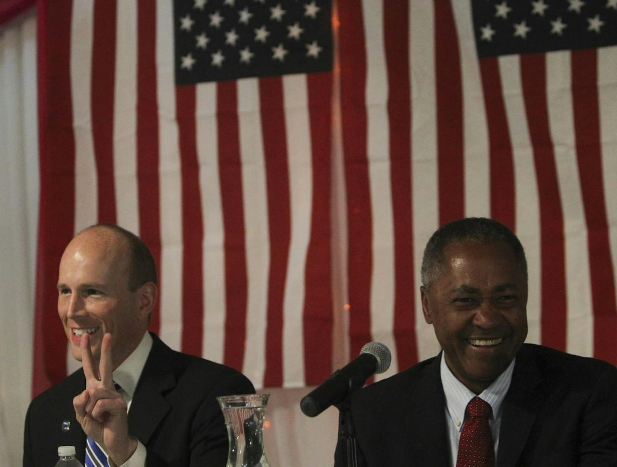 Mayoral candidate Gary Schiff flashes a peace sign before the start of the debate as fellow candidate Don Samuels looks on at Safari restaurant Friday, May 31, 2013, in Minneapolis, MN.