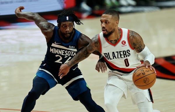 Trail Blazers guard Damian Lillard, defended by Wolves guard Patrick Beverley, shot only five of 17 from the field in the Wolves’ 116-111 victory on