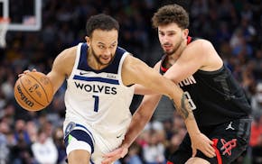 Minnesota Timberwolves forward Kyle Anderson (1) works around Houston Rockets center Alperen Sengun, right, during the second half of an NBA basketbal