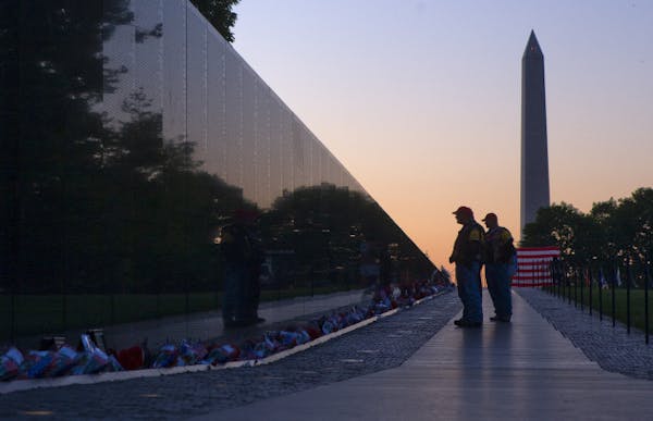 Visitors stopped to read the names on the Vietnam Memorial in Washington, D.C.