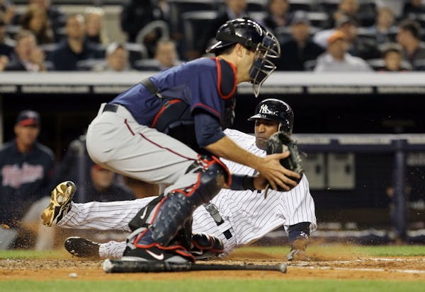 Eduardo Nunez of the New York Yankees scores a ron for the Yankees against the Twins during the 2012 season.
