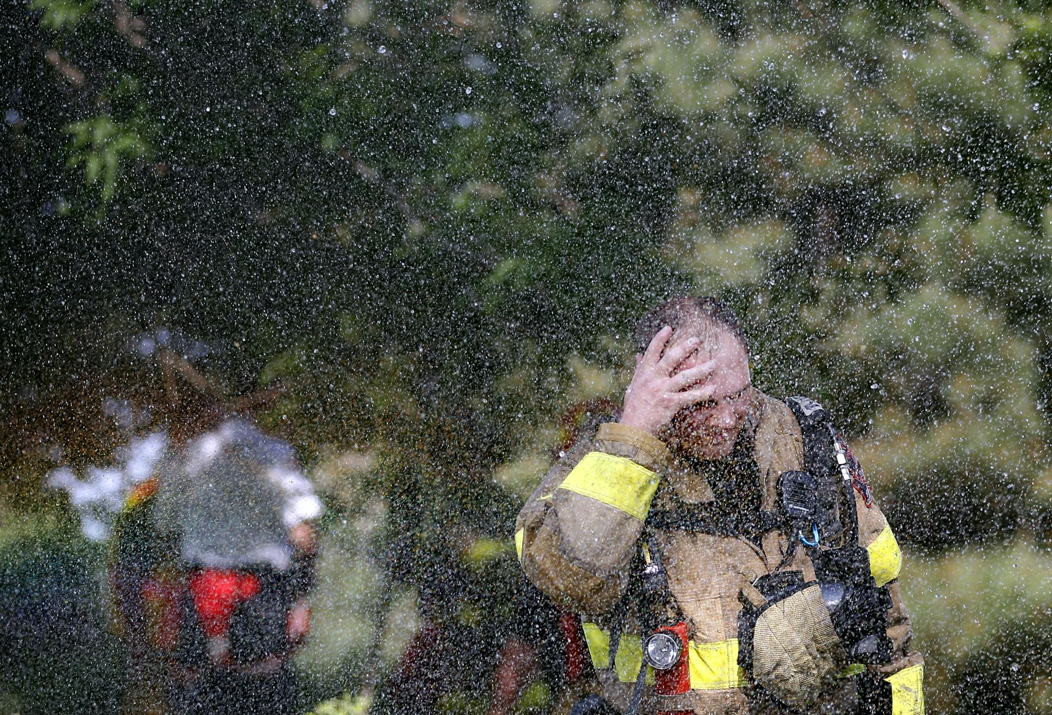 Greg Jurek of the Plymouth Fire Department cooled off after battling a blaze Tuesday at the Natchez Place condominum building in the 4600 block of Minnetonka Bouleveard in St. Louis Park
