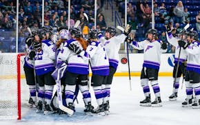 The Frost players gather at the goal to celebrate their victory and clinched playoff spot Saturday in Boston.