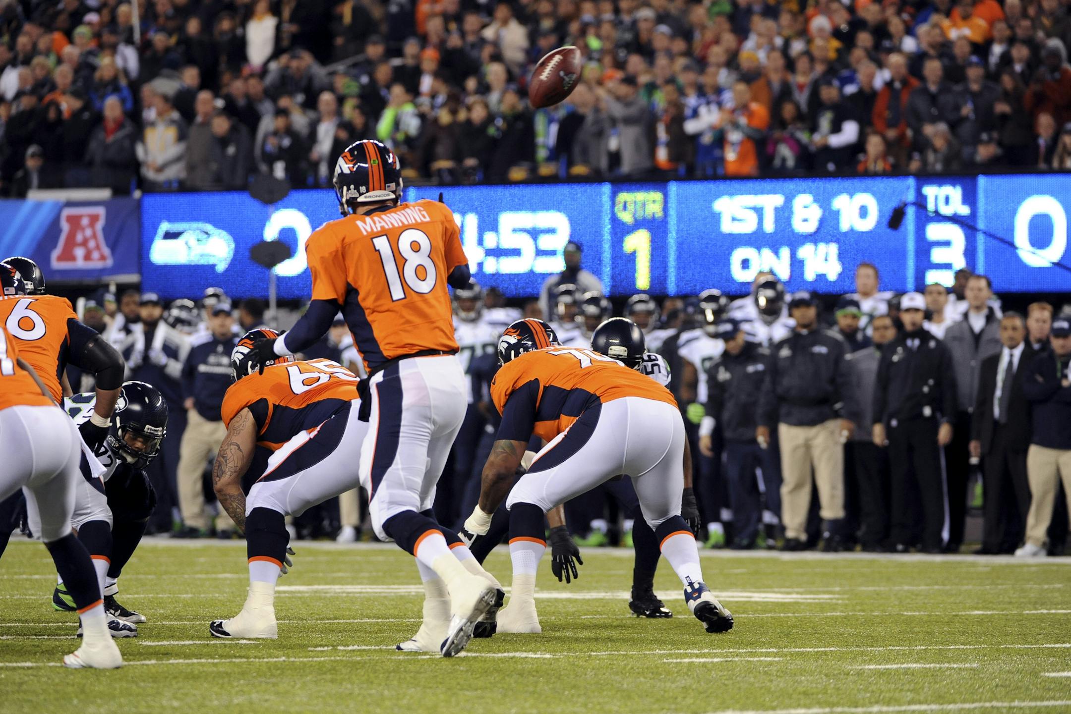 Denver Broncos quarterback Peyton Manning turns as the snap sails past him and into the end zone on the first play from scrimmage, resulting in a safety that gave the Seattle Seahawks a 2-0 lead in the NFL Super Bowl XLVIII football game at MetLife Stadium in East Rutherford, N.J., Feb. 2, 2014. (Barton Silverman/The New York Times)
