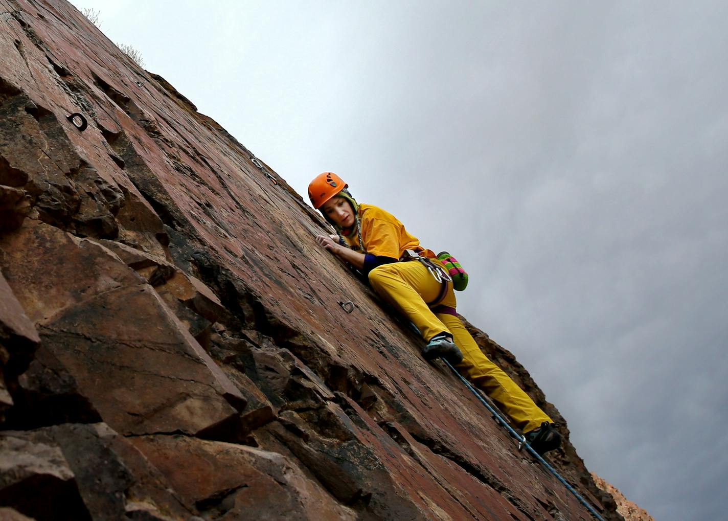 In this Tuesday, Jan. 19, 2016 photo, Iranian female rock climber, Farnaz Esmaeilzadeh, scales a natural cliff in a mountainous area outside the city of Zanjan, some 330 kilometers (207 miles) west of the capital Tehran, Iran. Esmaeilzadeh, 27, who has been climbing since she was 13, has distinguished herself in international competitions despite the barriers she faces as a female athlete in conservative Iran. (AP Photo/Ebrahim Noroozi)